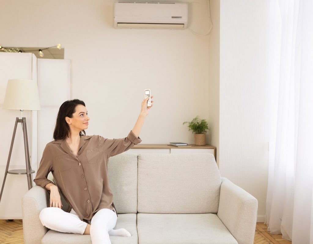woman switching air con temperature